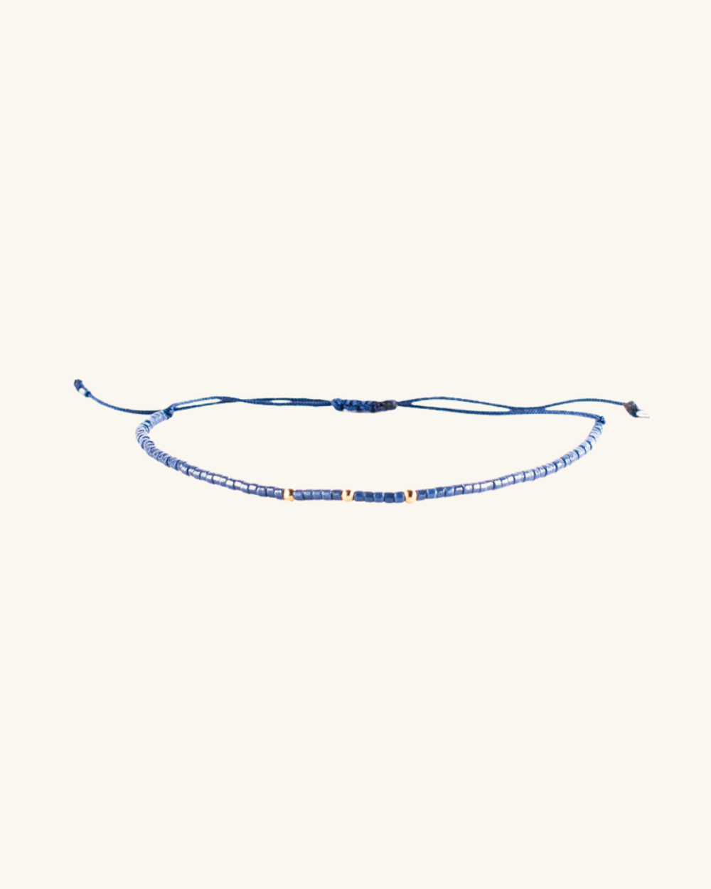 Pulsera Azul Acero con Mostacillas Bañadas en Oro