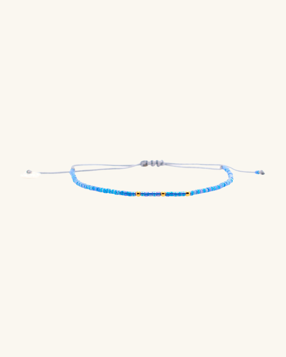 Pulsera Celeste Tornasol con Mostacillas Bañadas en Oro