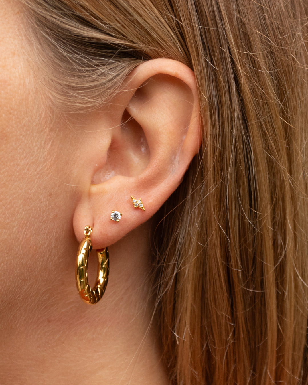 Piercing Rayo y Circones Bañado en Oro