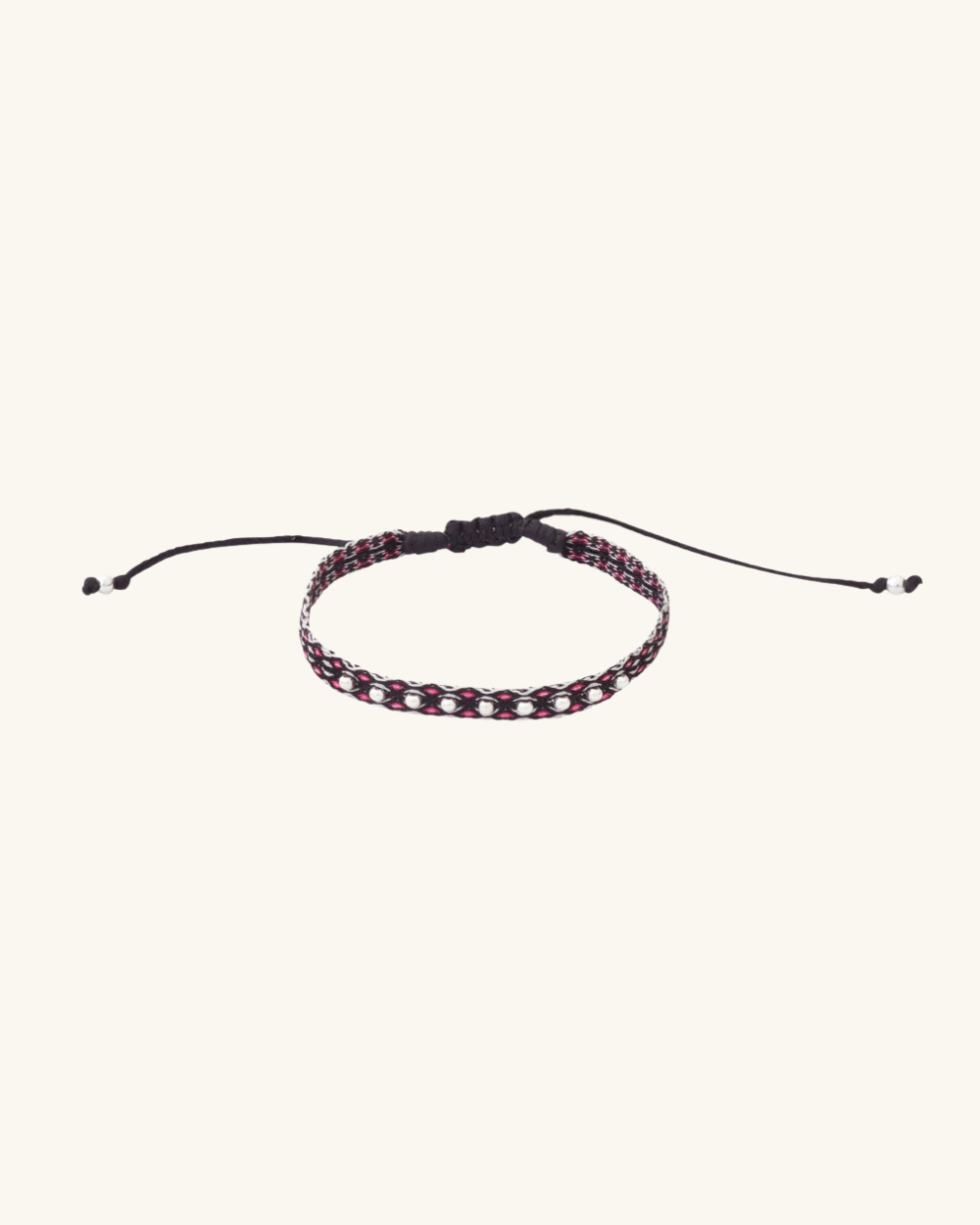 Pulsera Telar Fina con Diseño Negro, Blanco y Fucsia con Mostacillas de Plata