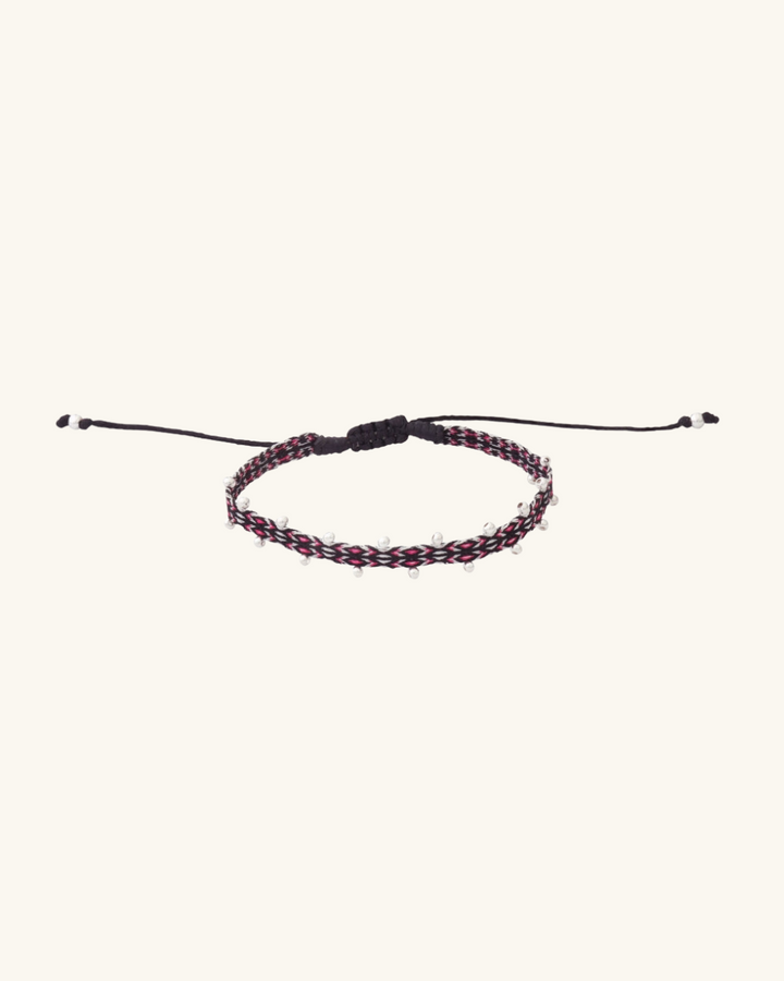 Pulsera Telar Fina con Diseño Negro, Blanco y  Fucsia con Mostacillas de Plata al Lado